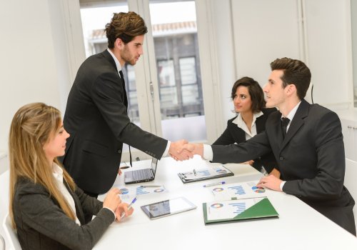 Business professionals completing vendor registration and government procurement onboarding during a formal meeting